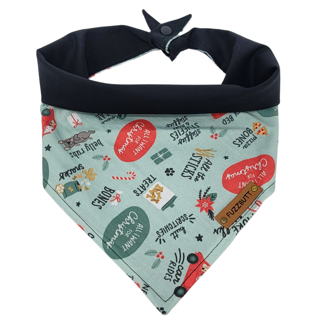 front view of a handmade Christmas presents dog bandana featuring everything your dog would want for Christmas: doggy bone, treats, car rides, butt scratches, belly rubs, snacks, and pizza bones; this pattern is called All I Want For Christmas Doggy