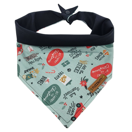 front view of a handmade Christmas presents dog bandana featuring everything your dog would want for Christmas: doggy bone, treats, car rides, butt scratches, belly rubs, snacks, and pizza bones; this pattern is called All I Want For Christmas Doggy