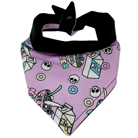 front view of a handmade nerdy dog bandana or handmade nerdy cat bandana with colorful cereal, milk carton and skulls; this pattern is called Cereal Killer 