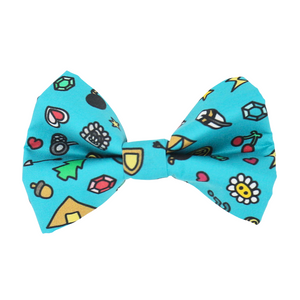 front view of a handmade dog bow tie or handmade cat bow tie with a pattern of colorful gamer doodles, swords, arrows, ghosts, gems, keys, trees, stars, coins, letters, weapons, turtles, etc.; this pattern is called Gamer Doodles 