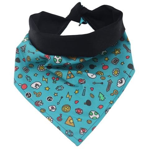 front view of a handmade dog bandana or handmade cat bandana with a pattern of colorful gamer doodles, swords, arrows, ghosts, gems, keys, trees, stars, coins, letters, weapons, turtles, etc.; this pattern is called Gamer Doodles 