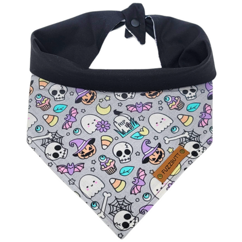 front view of a handmade Halloween dog bandana or handmade Halloween cat bandana with colorful bats, skulls, ghosts, spider webs, moons, tombstones, candy corn, eyeballs, cupcakes; this pattern is called Halloween Mashup