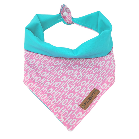 front view of a handmade Christmas  dog bandana or Christmas cat bandana featuring white Ho Ho Ho sign on a pink background with a bright teal backing; this pattern is called Pink Ho Ho Ho