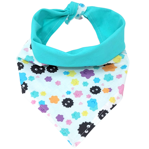 front view of a handmade Studio Ghibli dog bandana or handmade Studio Ghibli cat bandana featuring black soot sprites among colorful flowers; this pattern is called Soot Sprites